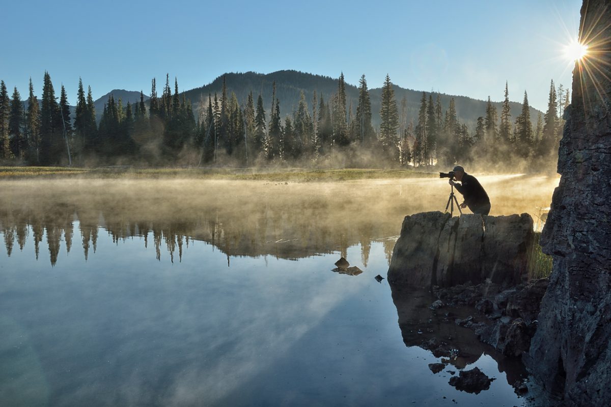 Photographer at sunrise at Sparks Lake, Central Oregon, USAModel release 0364